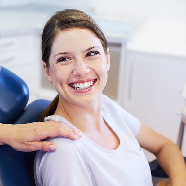 Smiling woman in dental chair 