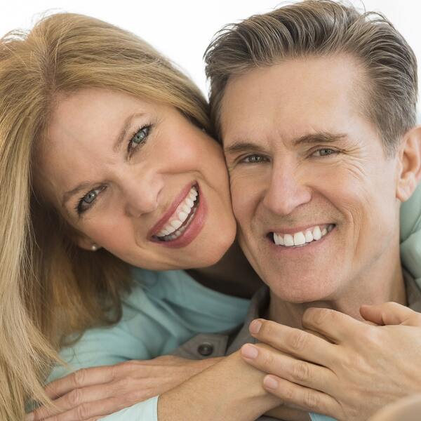 A couple smiling and hugging
