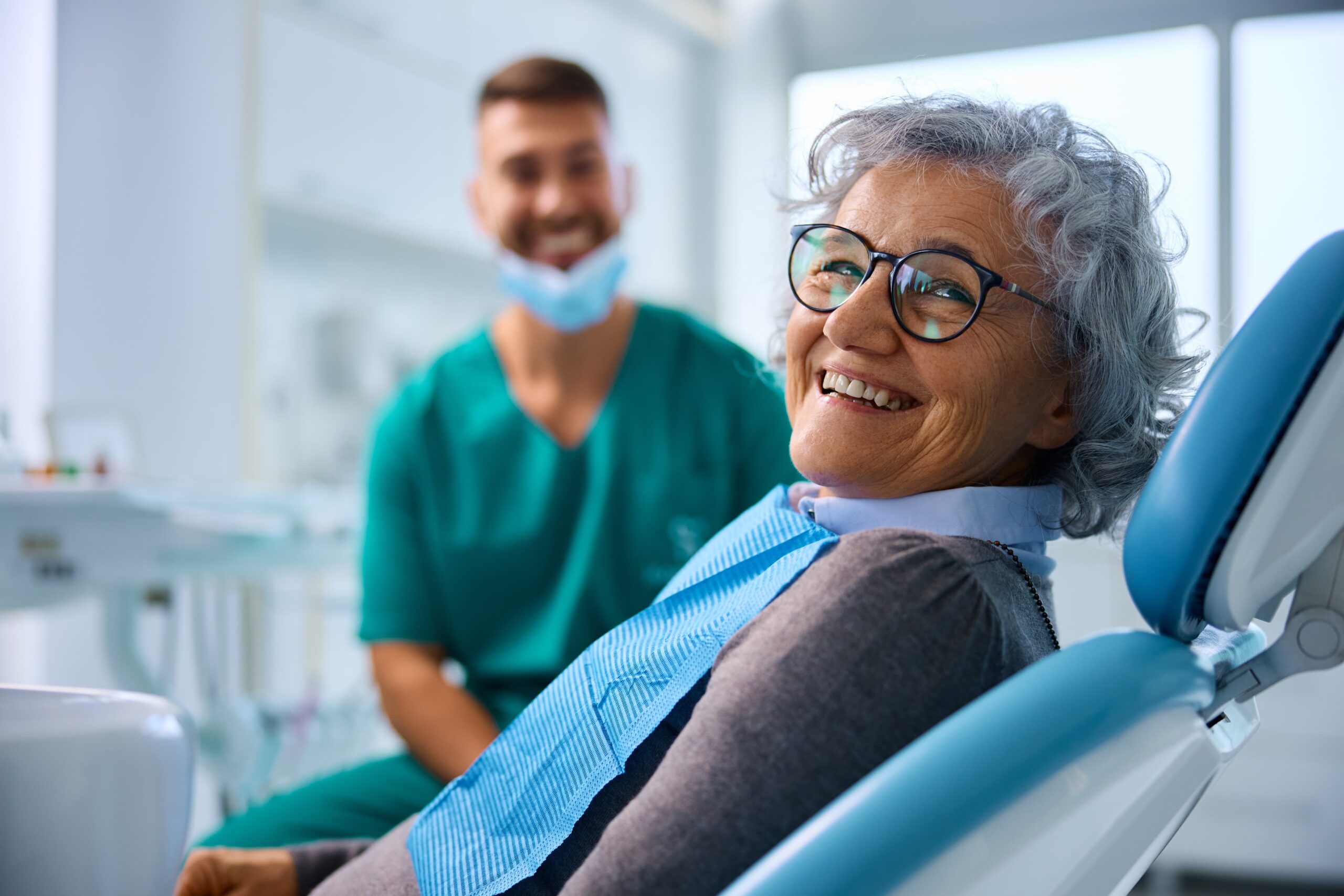 Woman with natural-looking dental implants happily smiling